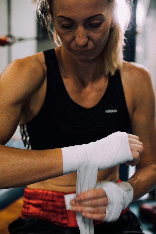 Boxer wrapping hands with boxing wraps for training