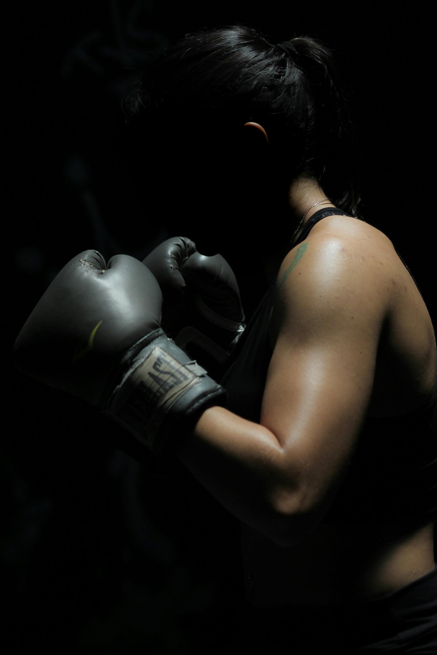 Boxing girl with boxing gloves with black background
