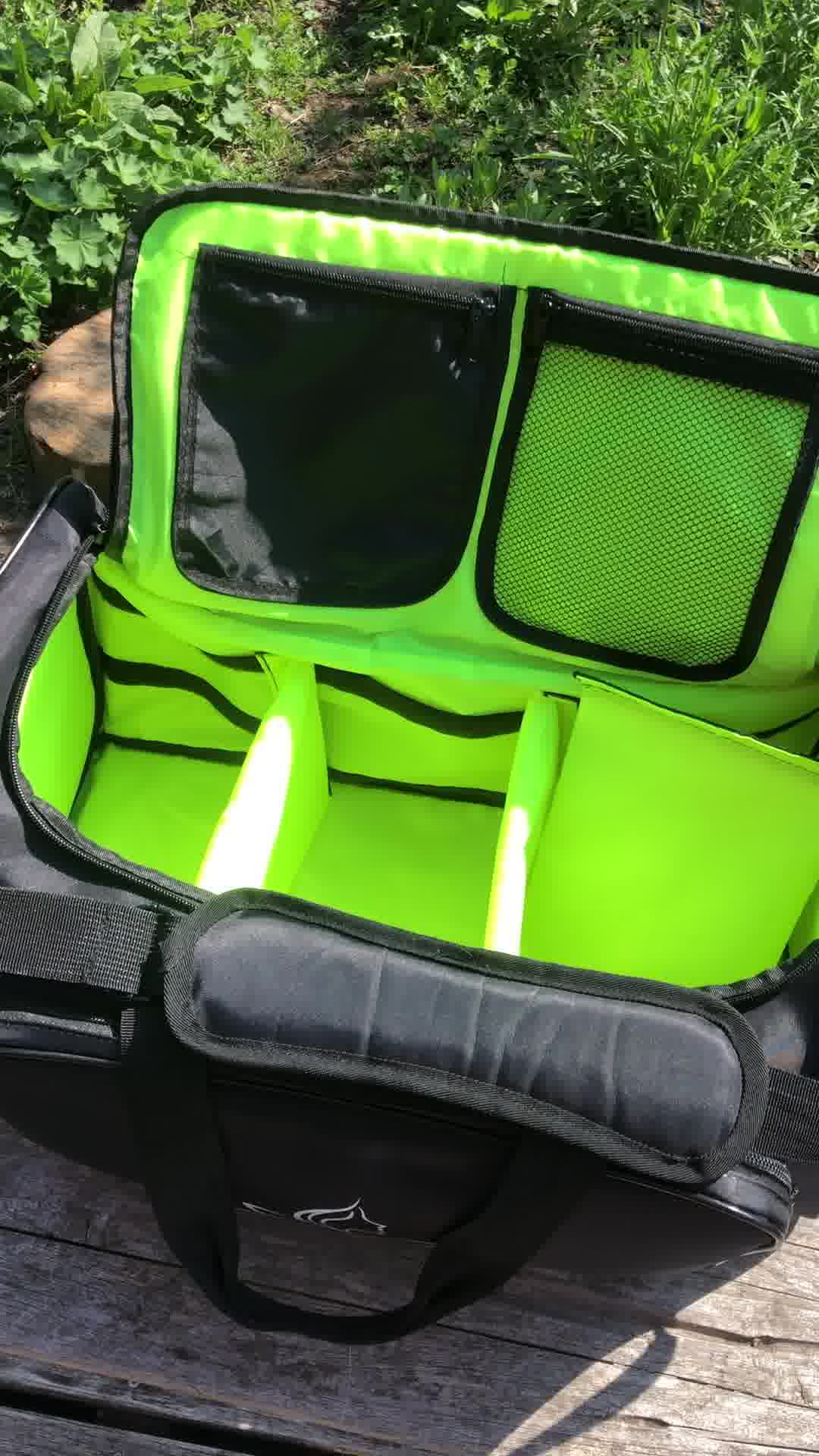 Neon green and black sports bag on a wooden surface with greenery in the background