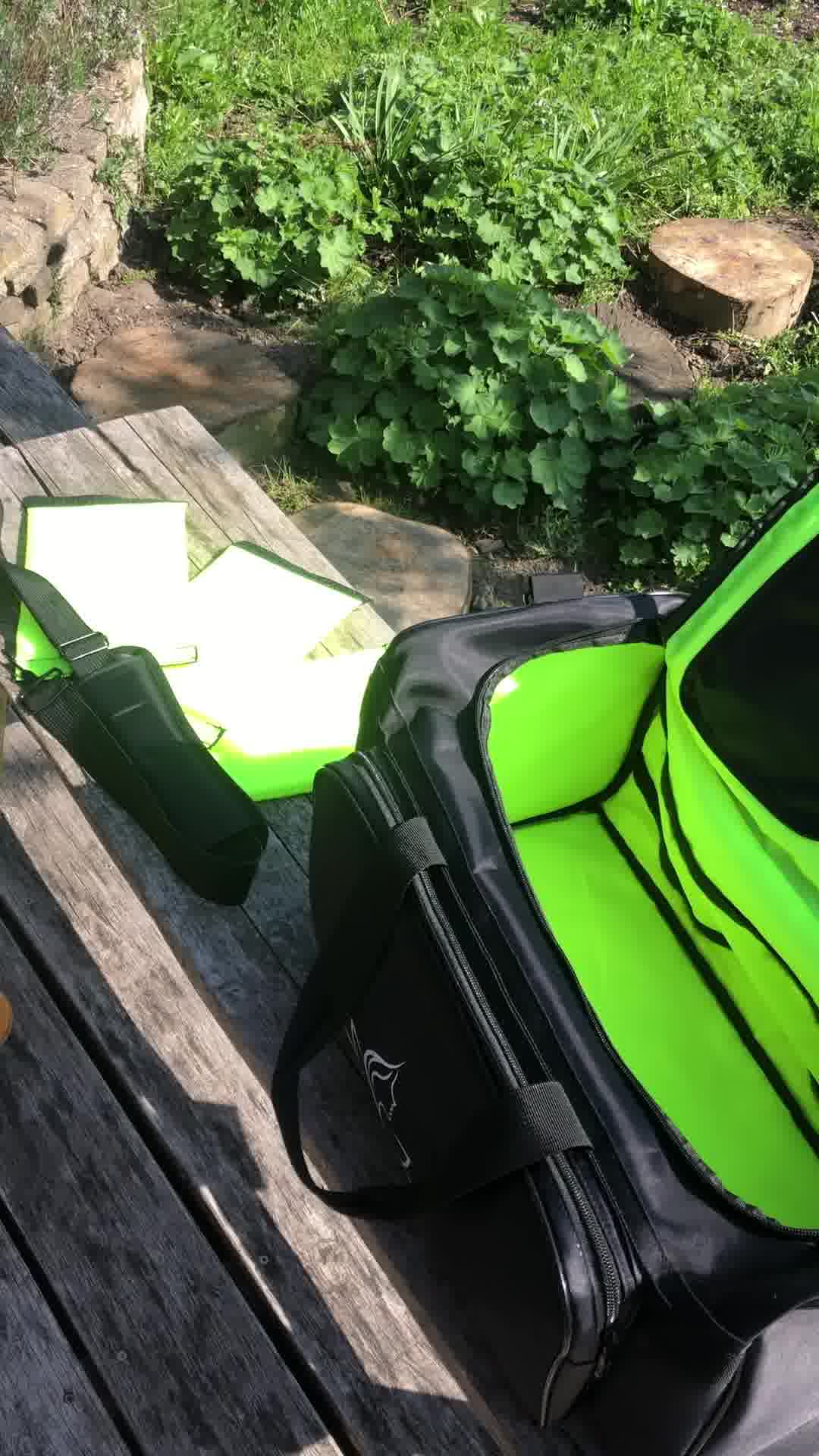 Black and green sports bag with adjustable shoulder strap and space dividers in nature