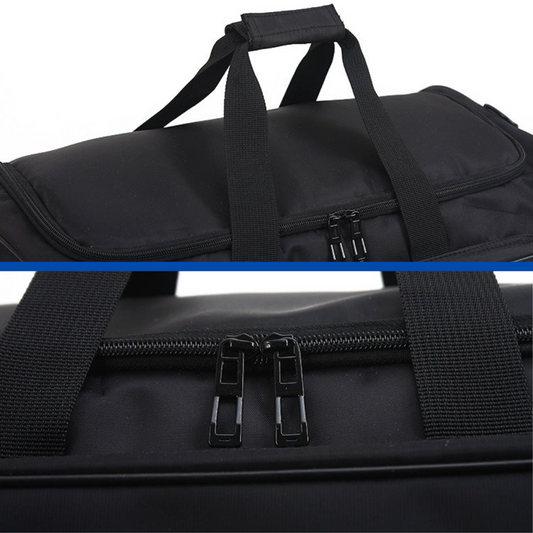 Black duffel bag with straps and zippers on a white background